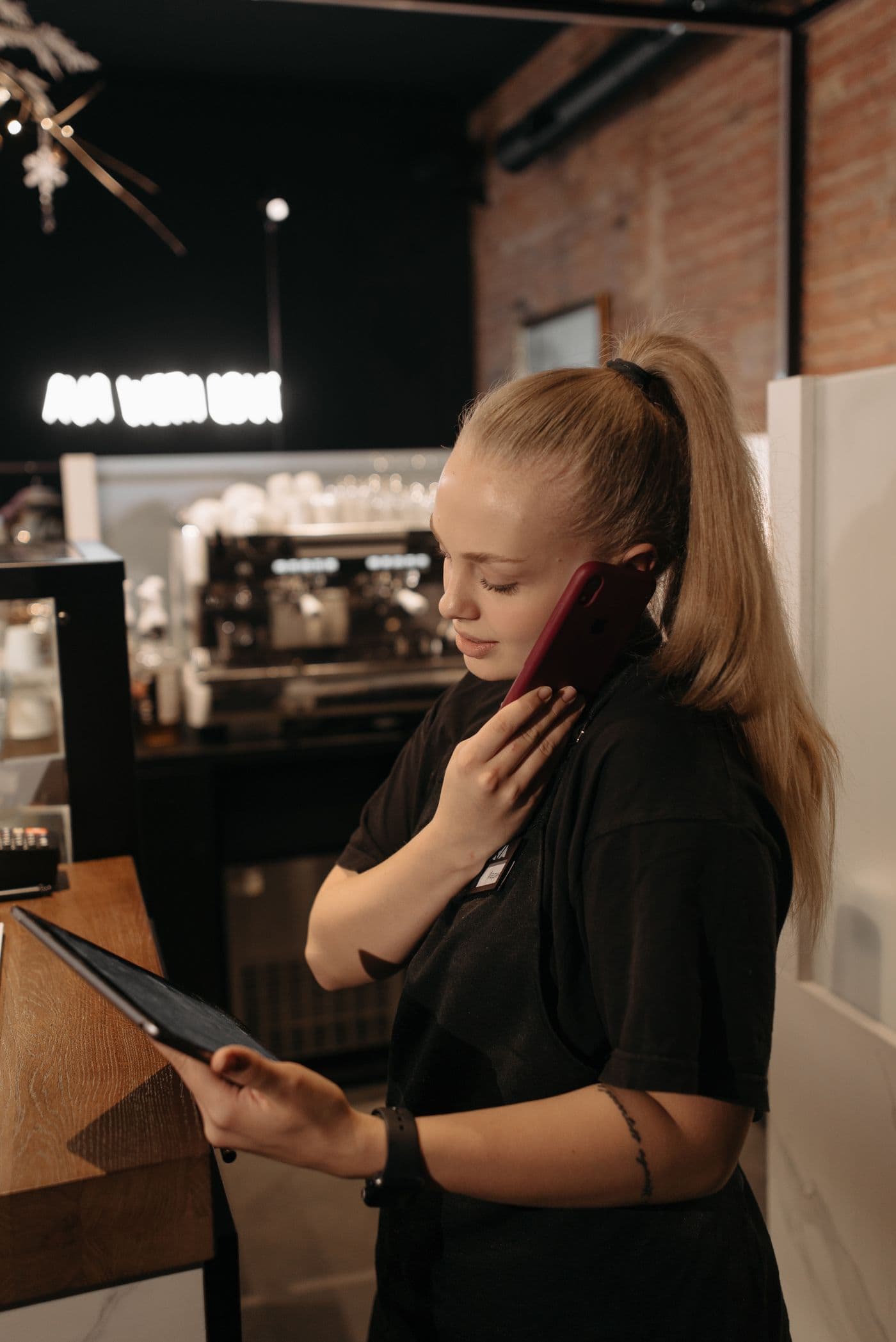 Restaurant host taking a reservation by phone